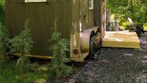A rustic wooden cabin with a sign reading "Dordtley" in a forested area.