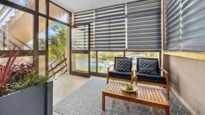 A balcony with a wooden table, two cushioned chairs, and a view of the outdoors. - Apartment Klara - beautiful pool apartment for 7 people (Rabac)