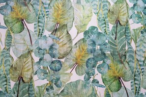 A pattern of green and blue leaves on a fabric.