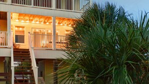 A two-story house with a balcony, a staircase, and a garage. - Oceanfront | Quiet Beach | 2 Balconies | Arcades | Kayaks (Port St. Joe)