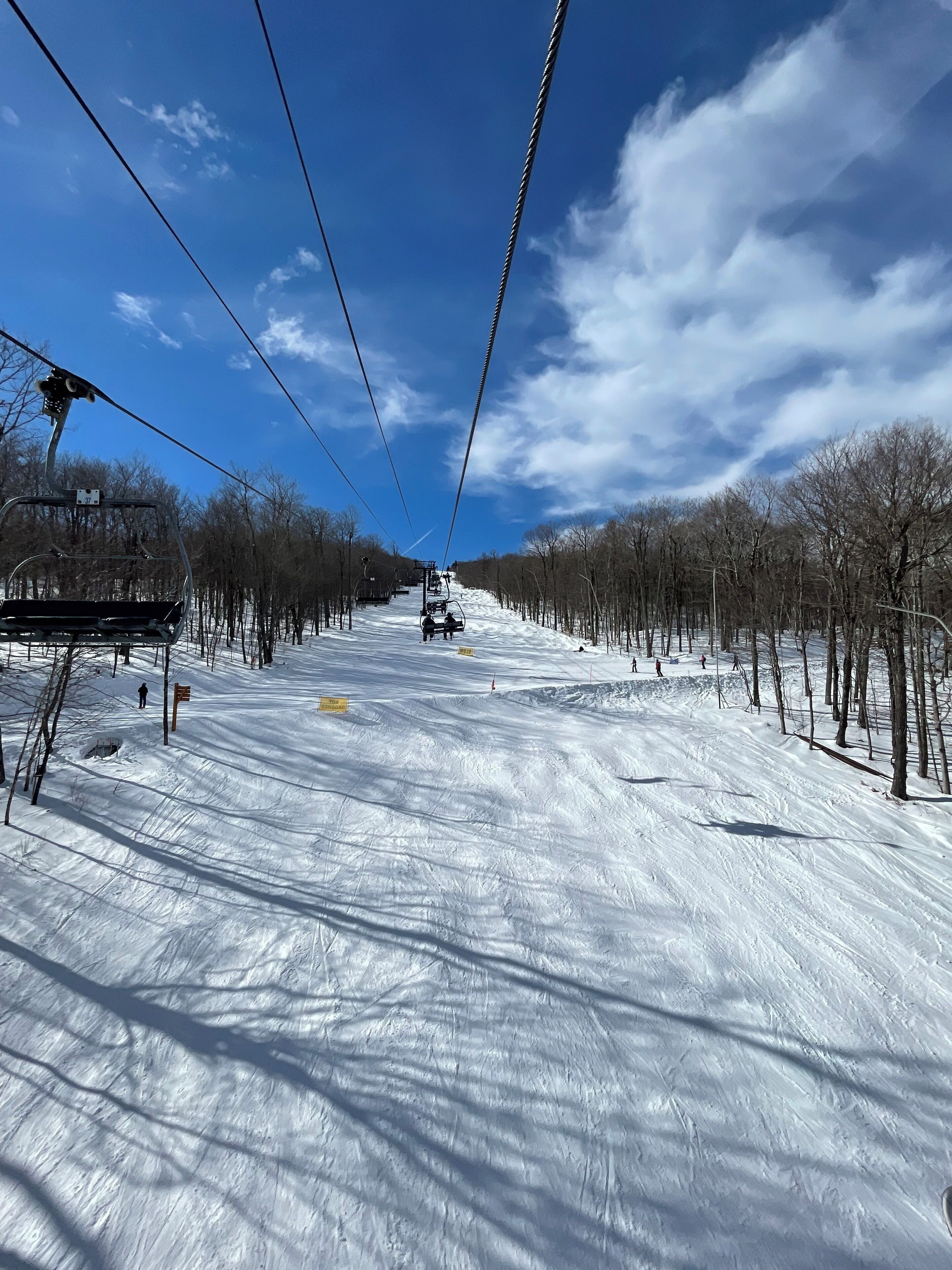A ski lift with a clear sky and snow-covered ground.
