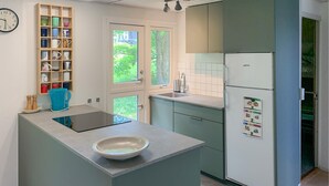 A modern kitchen with a central island, a built-in sink, and a refrigerator. - Amazing home in Ebeltoft with WiFi (Ebeltoft)