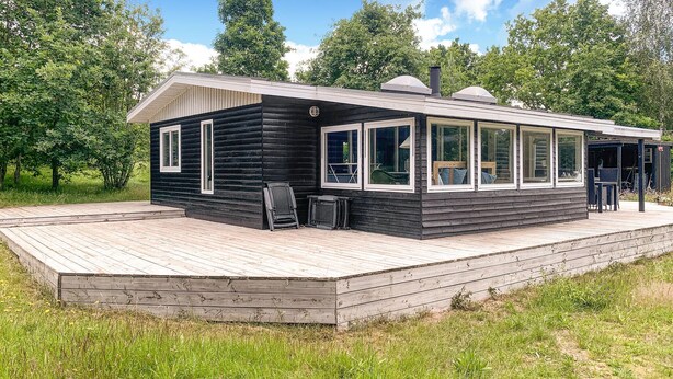 A cabin with a deck, large windows, and a chimney. - Amazing home in Ebeltoft with WiFi (Ebeltoft)