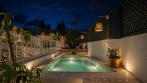 A nighttime swimming pool with a white fence, potted plants, and a starry sky. - Riad Belvi - Breakfast - 10mn Jemaa El Fnaa-Pool (Marrakech)