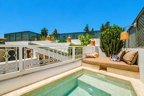 A pool area with a white railing, a seating area with cushions, and a cactus plant. - Riad Belvi - Breakfast - 10mn Jemaa El Fnaa-Pool (Marrakech)