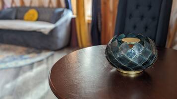 A dark wooden table with a glass bowl on top.