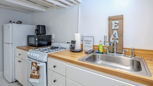 A kitchen with white appliances, a wooden countertop, a stainless steel sink, and a sign that says "Follow Your Dreams". - Cozy 1-bedroom apartment located in UNBEATABLE location Washington DC (Washington)