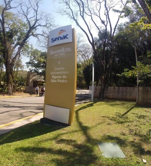 A hotel sign with the name 'Senac Grande Hotel São Pedro' and mentions 'Centro Universitário Água de São Pedro'.
