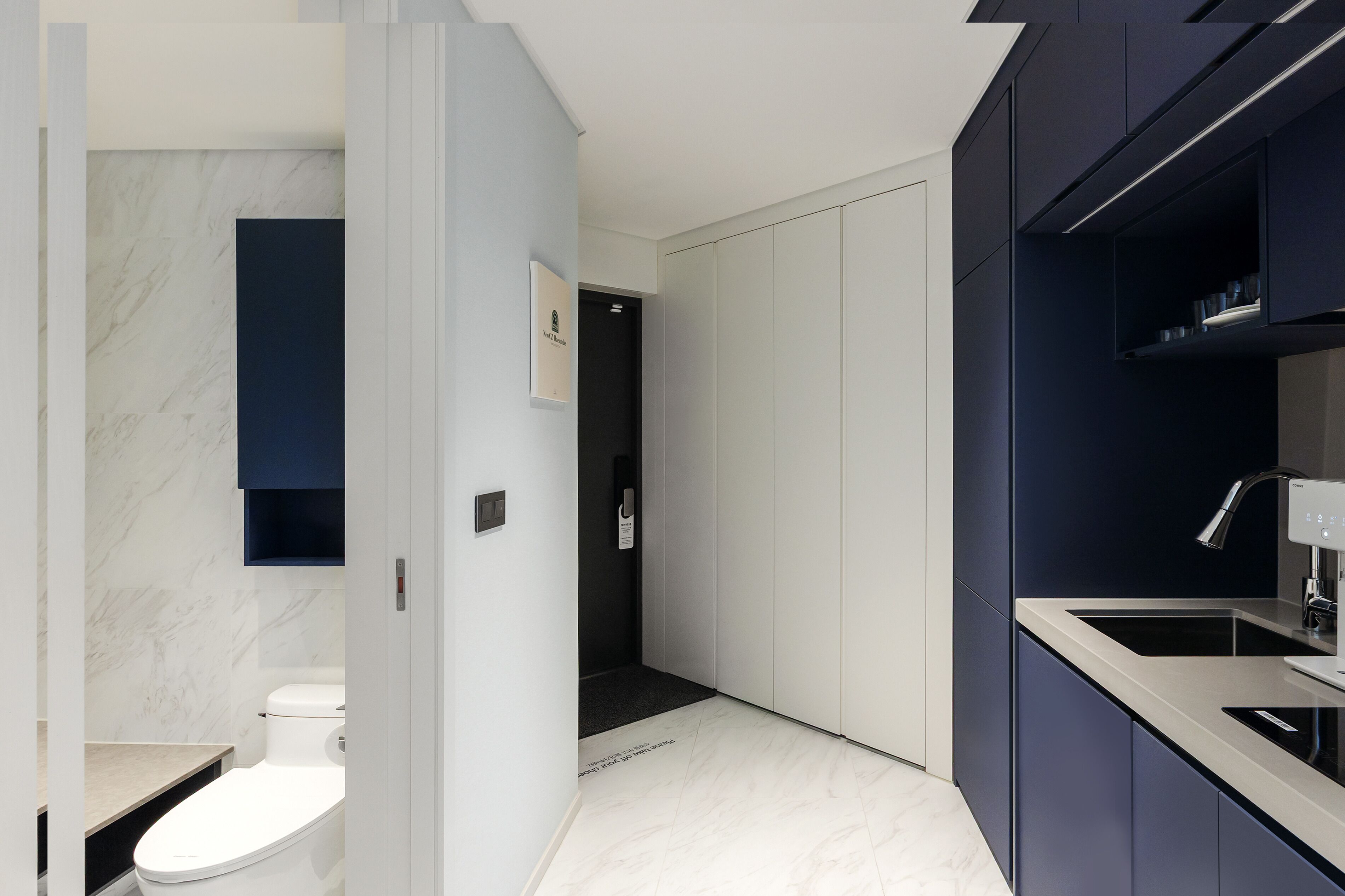 A modern bathroom with a toilet, a sink, and a shower area.