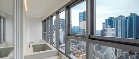 A high-rise interior with large windows offering a cityscape view.