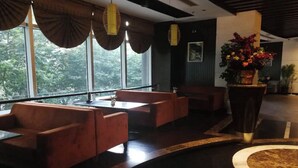 A modern interior with seating arrangements and large windows. - Shanghai StarChain New Space Time Hotel (Zhongshan Park Subway Station) (Shanghai)