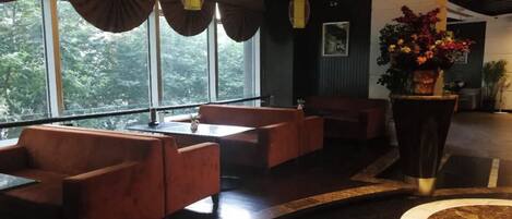 A modern interior with seating arrangements and large windows.
