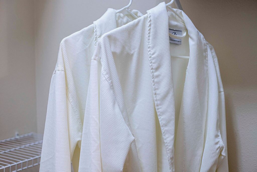 A white garment hanging on a white hanger.