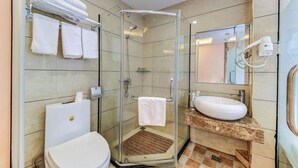 A modern bathroom with a glass-enclosed shower, a white sink, and a toilet. - StarChain Zengcuoan Hotel Xiamen (Xiamen)