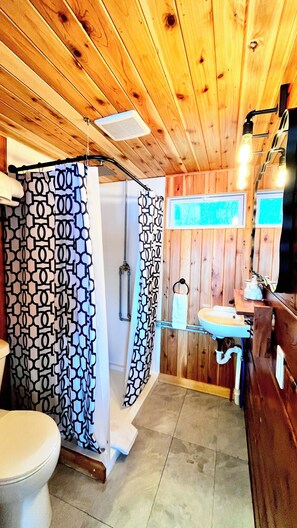 A wooden interior with a shower, toilet, and sink. - Lakefront Cabin w/ Dock & Kayaks, Fishing Escape
Marine Comfort - Cabin 8 (South Haven)