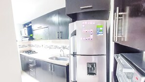 A modern kitchen with stainless steel appliances, a built-in oven, and a microwave. - Very natural, Peaceful and Centrally in Medellín (Envigado)