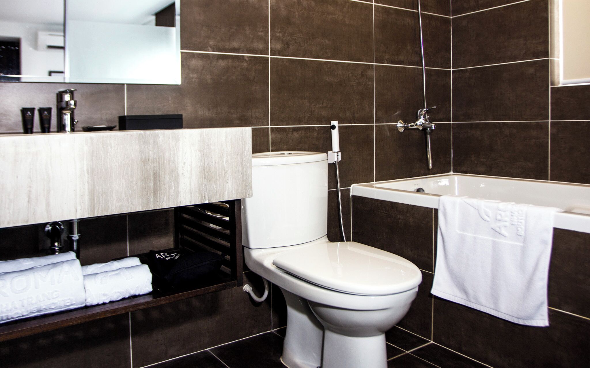 A modern bathroom with a toilet, sink, and bathtub.