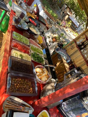 A buffet table with various food items and condiments.