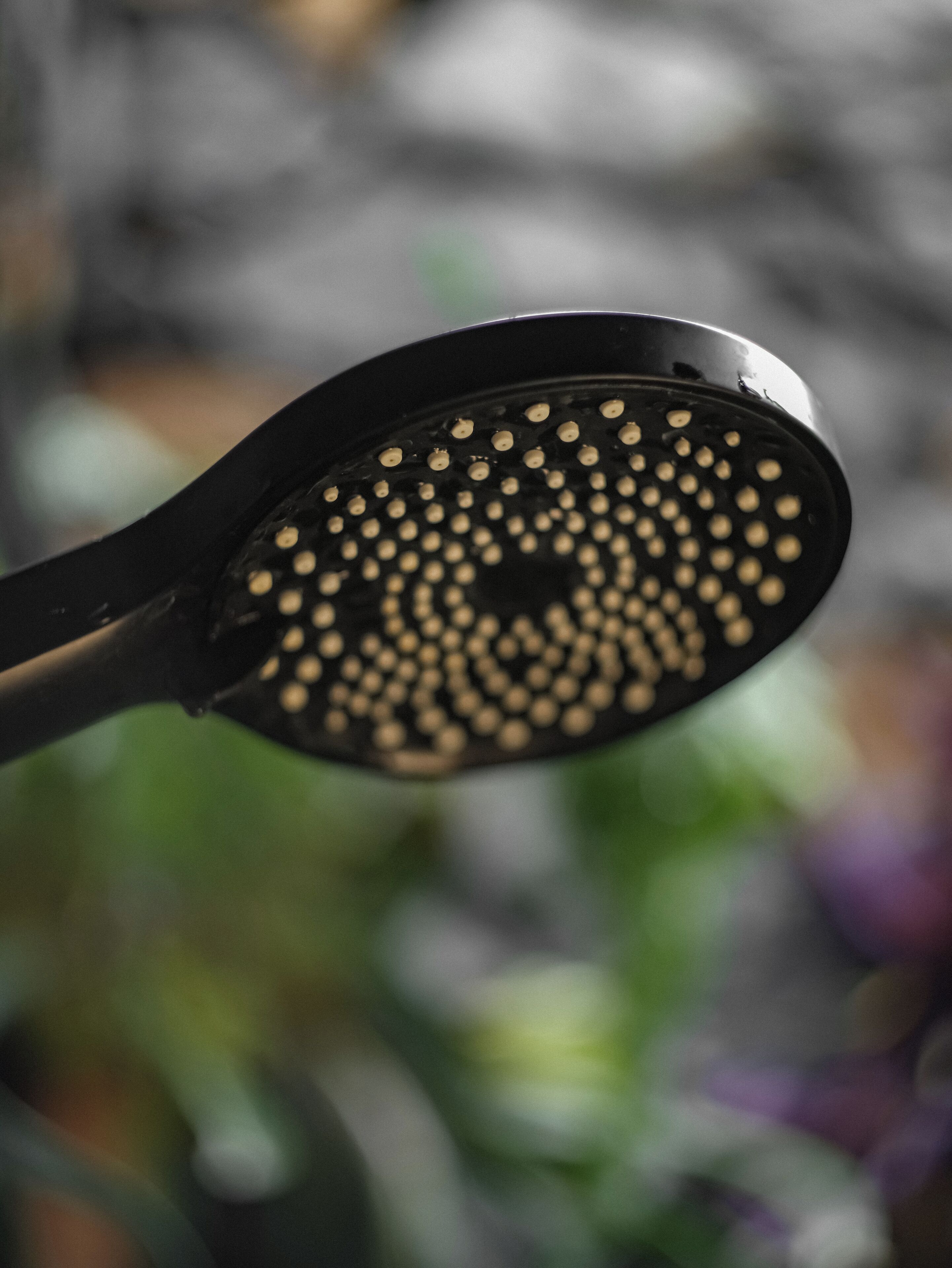 A close-up of a black object with a pattern of small holes.
