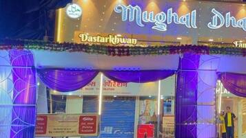 A restaurant named 'Mughal Dhaka' with a signboard and festive decorations.