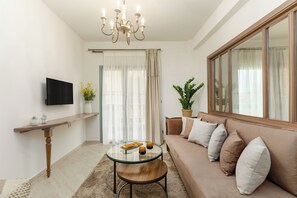 Deluxe Suite, Balcony | Living area