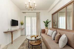 Deluxe Suite, Balcony | Living area | TV