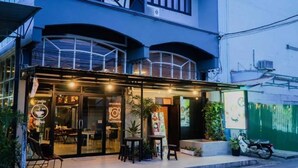 A restaurant with outdoor seating, a covered patio, and a motorcycle parked outside. - OYO 1189 Home Orion BLDG 1 Bedroom XL (Dubai)