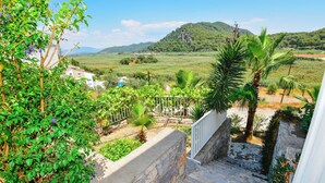 A staircase leading to a balcony overlooking a lush garden and a distant mountain. - Beautiful Detached Villa With Private Pool And Stunning Views,Walkable to Town. (Dalanan)