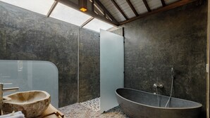 A modern bathroom with a freestanding bathtub, a stone basin, and a wooden tray with towels. - Oemah Cinta Ubud Villa (Tegallalang)