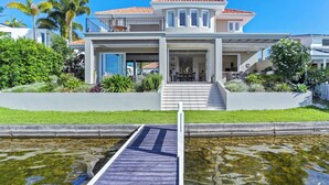 A modern two-story house with a balcony, a swimming pool, and a well-maintained garden. - Elegance On The River, Noosa Waters (Noosaville)