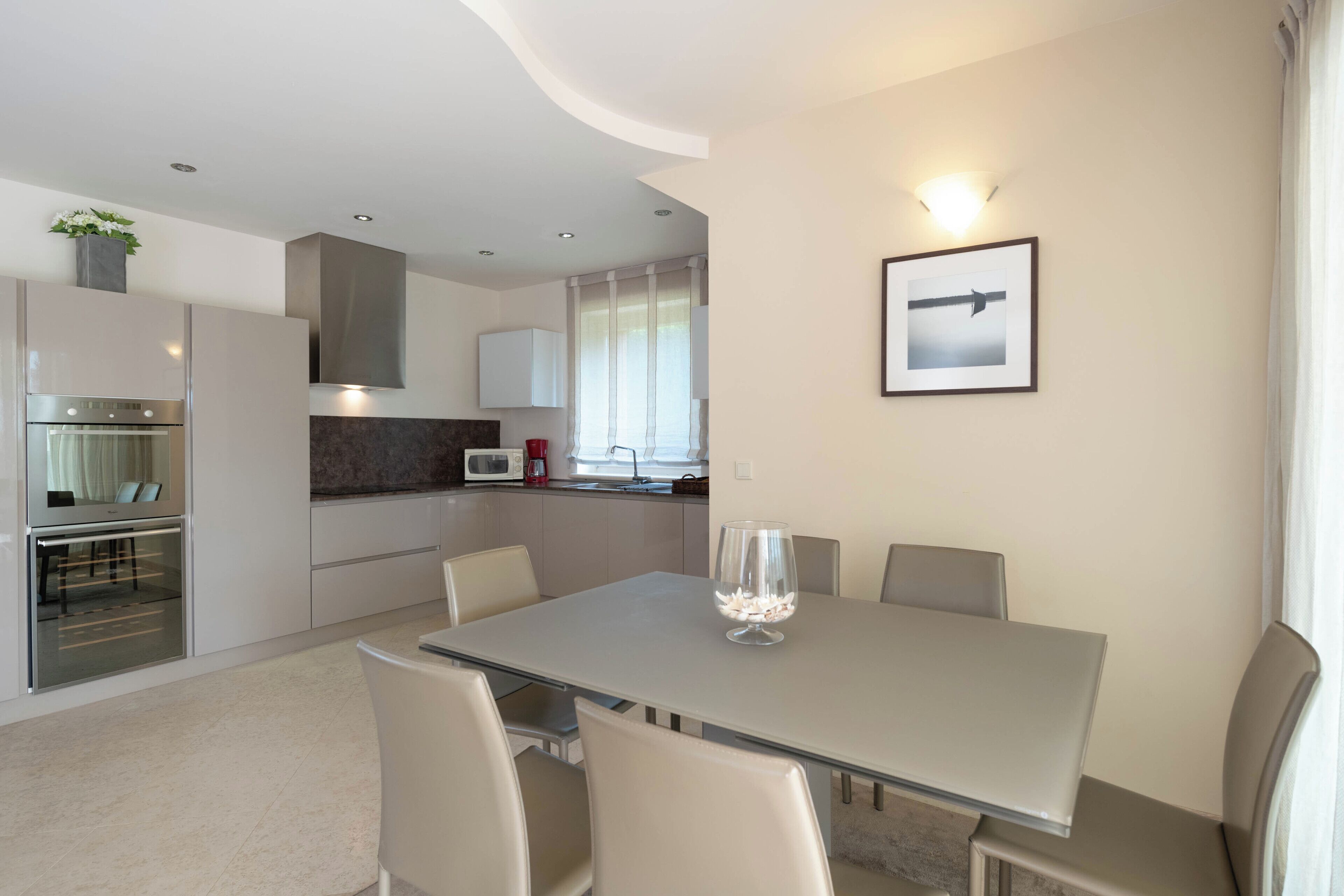 A modern kitchen with a dining area.