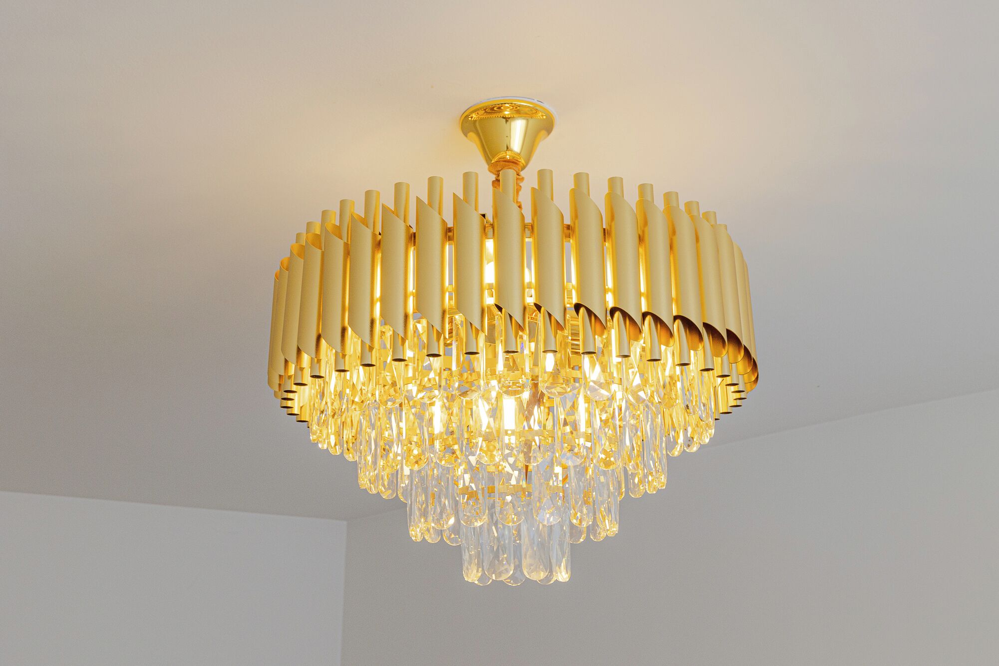 A chandelier with a gold finish and crystal elements.