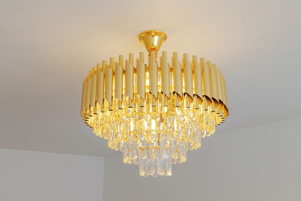 A chandelier with a gold finish and crystal elements.