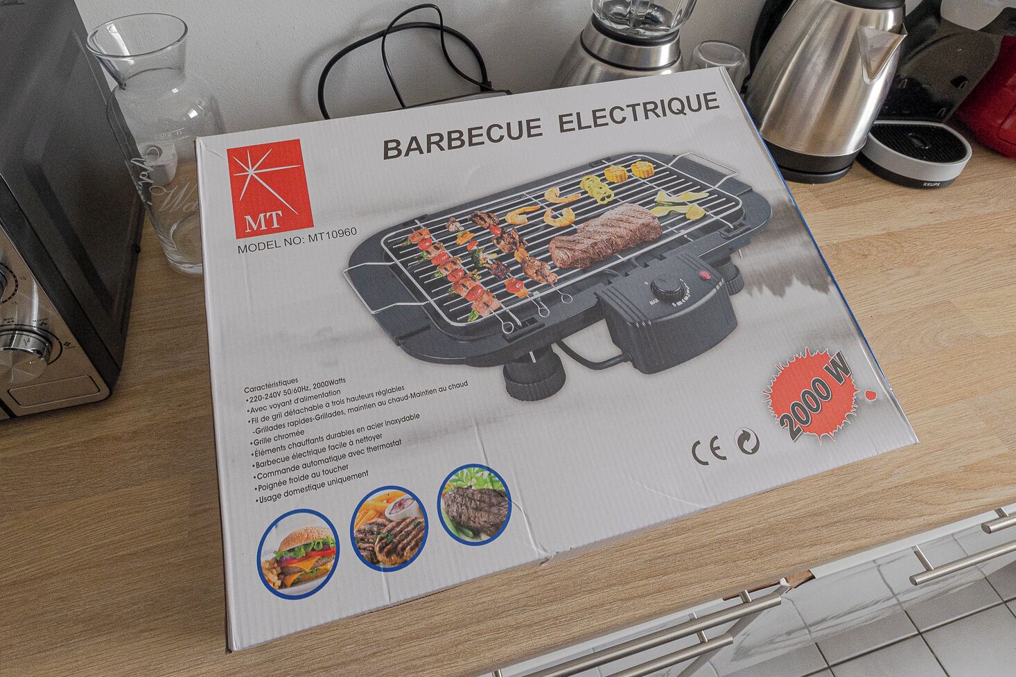 A barbecue electric grill with a 2000W power rating, model number MT10960, and features like a detachable grill, drip tray, and easy-to-clean elements.