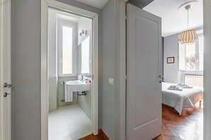 Ein Hotelzimmer mit Bad, Bett und Fenster.