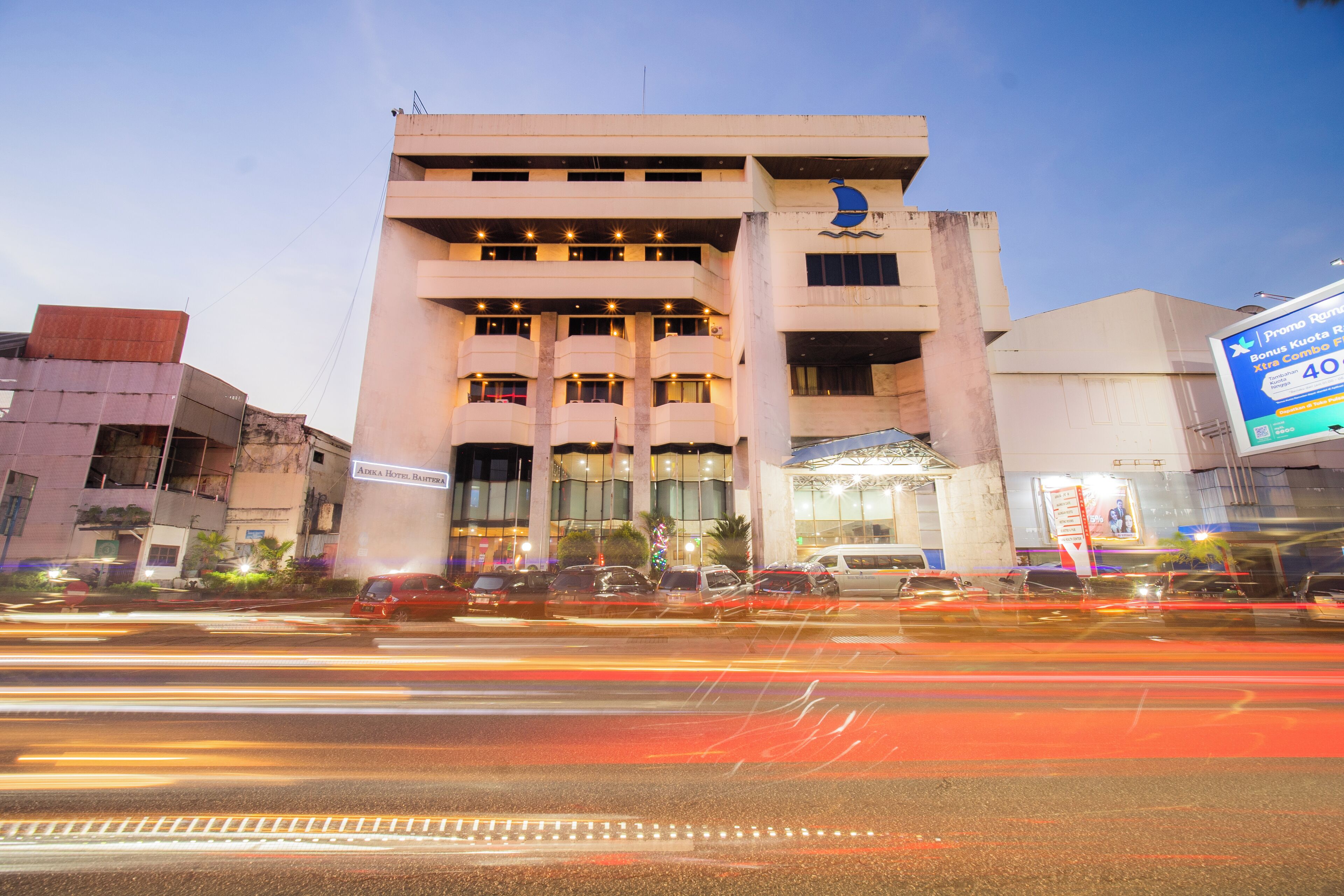 A multi-story building with a prominent sign on the right side.