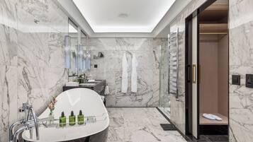 A modern bathroom with a freestanding bathtub, a vanity with a mirror, and a glass shower enclosure.