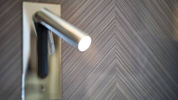 A wall-mounted light fixture with a metallic finish and a rectangular base.