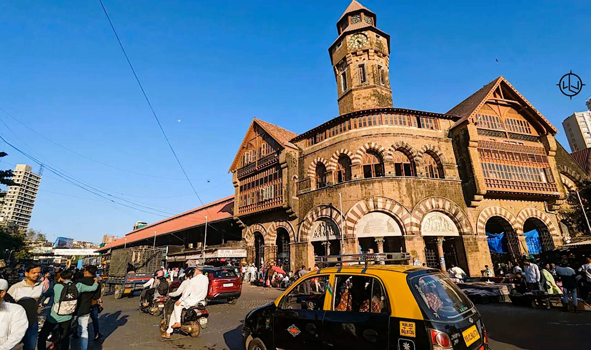 A historic building with a prominent tower and arched windows.