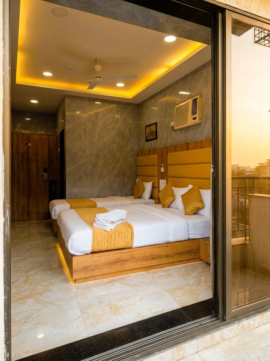 A modern hotel room with a large bed, a ceiling fan, and a view through a glass door.