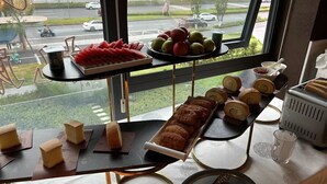 A breakfast buffet with various pastries, fruits, and beverages. - RunhaoHOTEL (Chengdu)