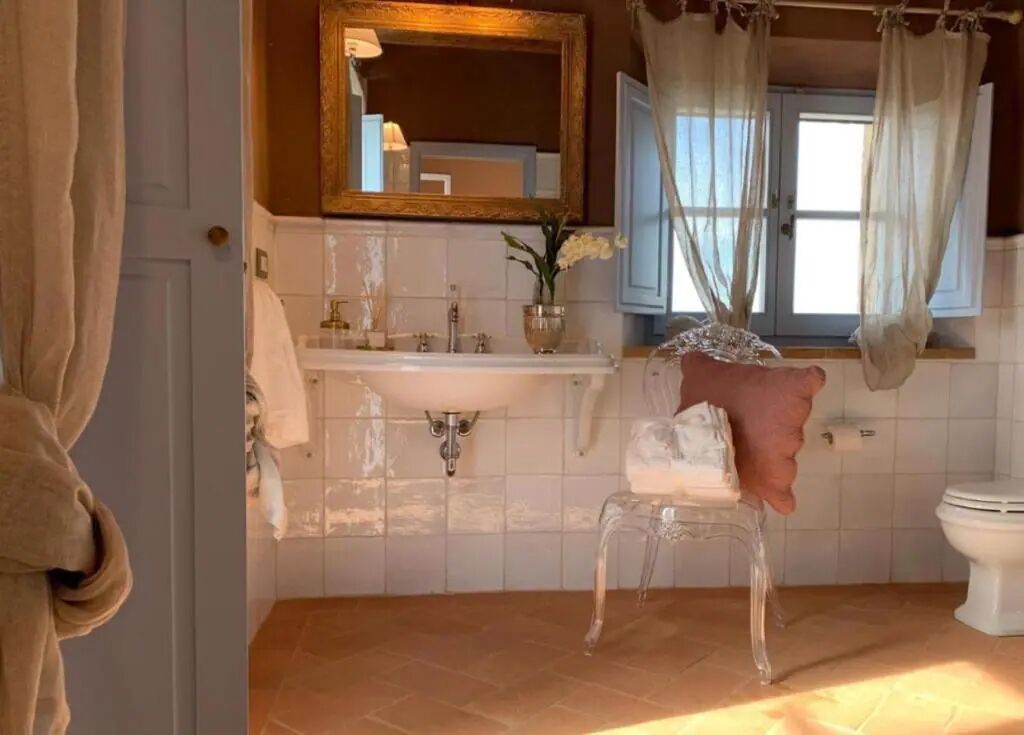 A bathroom with a sink, mirror, and toilet.