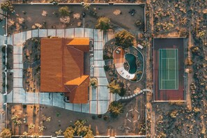 Overhead view of the villa, pool and court