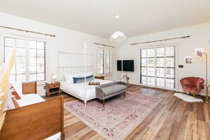 Bedroom 1, canopy bed and TV wall