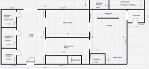 A floor plan of a hotel with multiple bedrooms, a dining room, a living room, a bar, a kitchen, and a yoga studio.