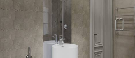 Une salle de bain moderne dotée d’une grande baignoire, de deux lavabos et d’un espace douche.