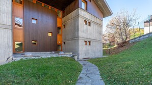 Un edificio moderno con un sendero de piedra que conduce a una entrada de madera.