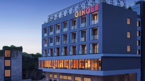 A modern hotel with a prominent "GINGER" sign, multiple floors, and large windows. - Ginger Udaipur Shastri Circle (Udaipur)