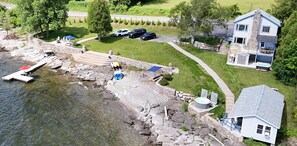 A lakeside property with a dock, a hot tub, and a stone staircase leading to a house with a stone facade and a balcony. - ZaLo Manor Unit Lakefront hot tub, pets (Peru)