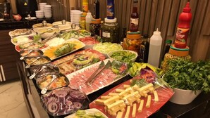 A buffet with various food items and condiments. - el masaadya hotel  (Cairo)